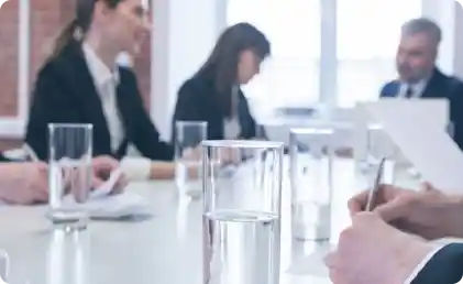 industries-office-water meeting table with glasses of water and business people